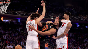 Nov 14, 2025; New York, New York, USA; New York Knicks center Karl-Anthony Towns (32) loses the ball as he drives to the basket against Miami Heat forward Jaime Jaquez Jr. (11) and center Kel'el Ware (7) during the first quarter at Madison Square Garden. Mandatory Credit: Brad Penner-Imagn Images