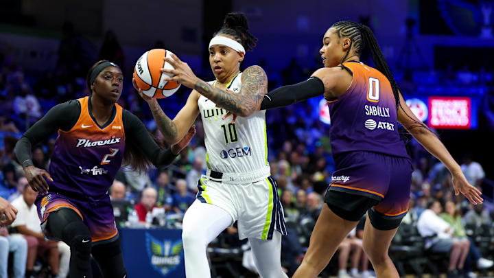 Jul 3, 2025; Arlington, Texas, USA;  Dallas Wings guard Aziaha James (10) drives to the basket past Phoenix Mercury forward Satou Sabally (0) and Phoenix Mercury guard Kahleah Copper (2) during the first half at College Park Center. Mandatory Credit: Kevin Jairaj-Imagn Images