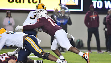 Oct 24, 2025; Blacksburg, Virginia, USA;  Virginia Tech Hokies defensive lineman Kemari Copeland (13) sacks California Golden Bears quarterback Jaron-Keawe Sagapolutele (3) during the first quarter at Lane Stadium. Mandatory Credit: Brian Bishop-Imagn Images