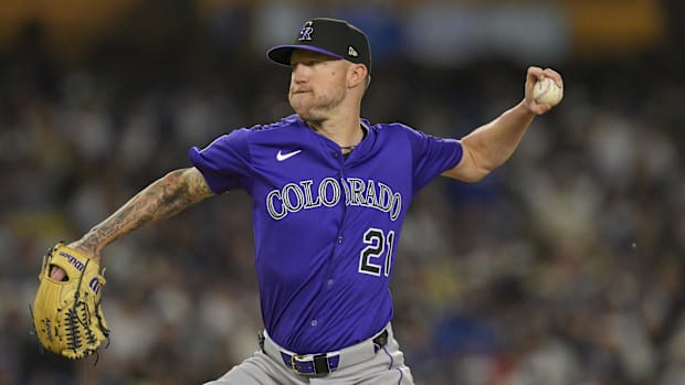 Colorado Rockies pitcher Kyle Freeland throws wearing a purple jersey.