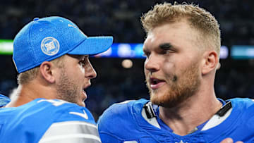 Detroit Lions quarterback Jared Goff (16) celebrates 26-20 win over Los Angeles Rams with defensive end Aidan Hutchinson (97) 