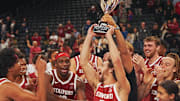 Benny Gealer raises the trophy after making a three-pointer with .08 seconds left to give Stanford the win over St. Louis University in the Acrisure Invitational Champioship game at Acrisure Arena in Palm Desert, Calif., Nov. 28, 2025.