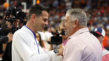 Feb 8, 2025; Auburn, Alabama, USA;  Florida Gators head coach Todd Golden talks with Auburn Tigers head coach Bruce Pearl before their game at Neville Arena. Mandatory Credit: John Reed-Imagn Images