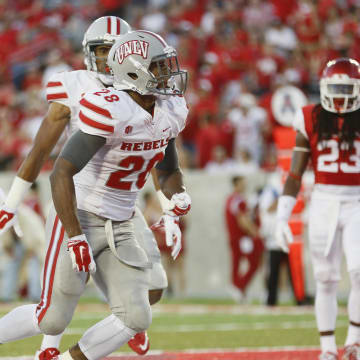 Sep 20, 2014; Houston, TX, USA; UNLV Rebels running back Keith Whitely (28) dives over the goal line to score a touchdown against the Houston Cougars during the first half at Houston Football Stadium. 