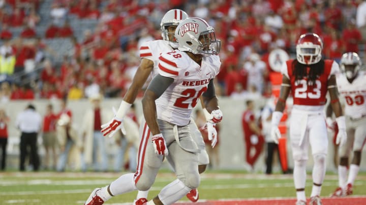 Sep 20, 2014; Houston, TX, USA; UNLV Rebels running back Keith Whitely (28) dives over the goal line to score a touchdown against the Houston Cougars during the first half at Houston Football Stadium. 