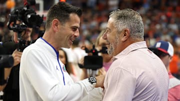 Feb 8, 2025; Auburn, Alabama, USA;  Florida Gators head coach Todd Golden talks with Auburn Tigers head coach Bruce Pearl before their game at Neville Arena. Mandatory Credit: John Reed-Imagn Images