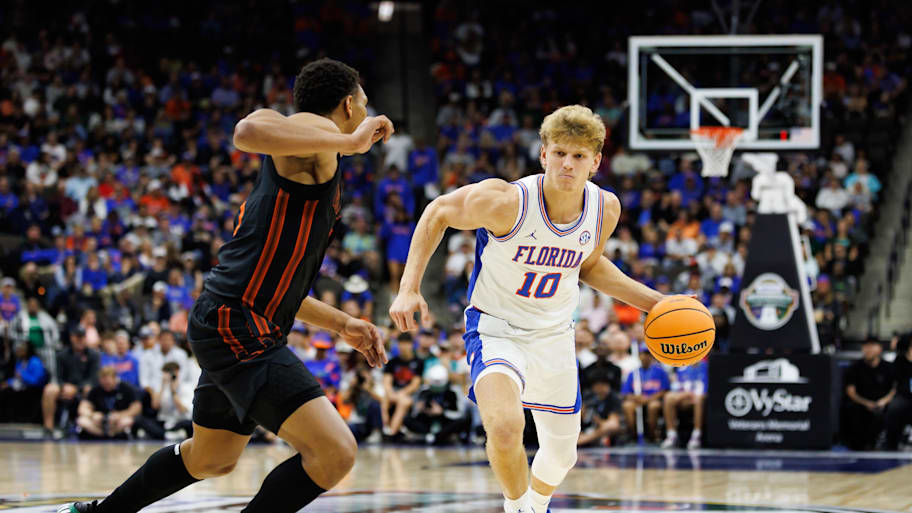 Florida forward Thomas Haugh drives to the basket against Miami forward Malik Reneau.