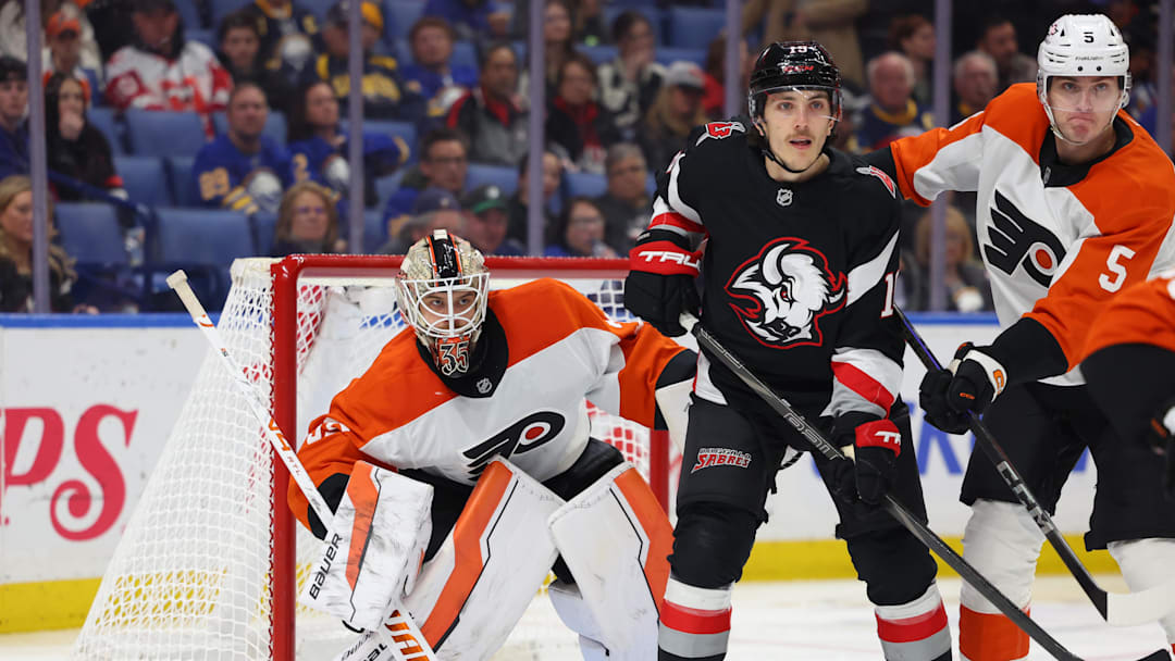 Apr 17, 2025; Buffalo, New York, USA;  Philadelphia Flyers defenseman Egor Zamula (5) and Buffalo Sabres center Peyton Krebs (19) battle for position in front of Philadelphia Flyers goaltender Aleksei Kolosov (35) during the second period at KeyBank Center. Mandatory Credit: Timothy T. Ludwig-Imagn Images