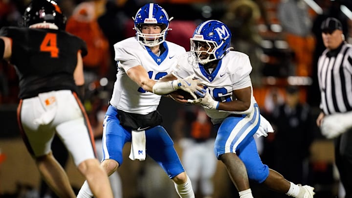 McCallie's Elliott Drapeau (12) hands off to Keylan Syam (26) during the third quarter against Ensworth at Ensworth High School in Nashville, Tenn., Friday, Nov. 22, 2024.