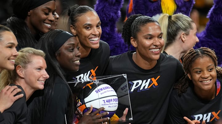 Phoenix Mercury players gather around teammate DeWanna Bonner as she is announced as the third all-time scorer in the WNBA before they play the Los Angeles Sparks at PHX Arena in Phoenix, on Sept. 9, 2025.