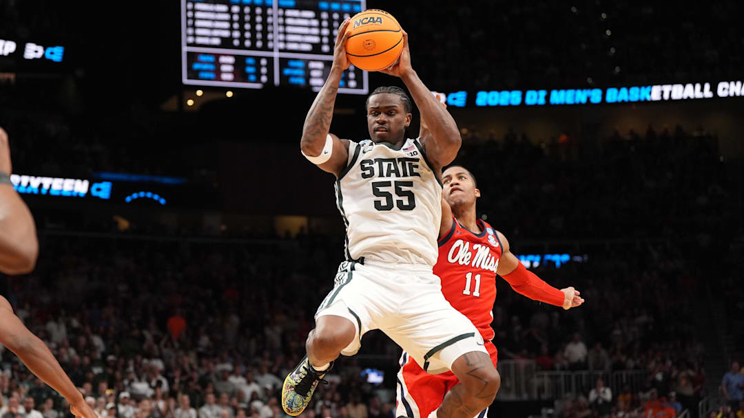 Mar 28, 2025; Atlanta, GA, USA; Michigan State Spartans forward Coen Carr (55) rebounds against Mississippi Rebels guard Matthew Murrell (11) in the second half of a South Regional semifinal of the 2025 NCAA tournament at State Farm Arena. Mandatory Credit: Dale Zanine-Imagn Images