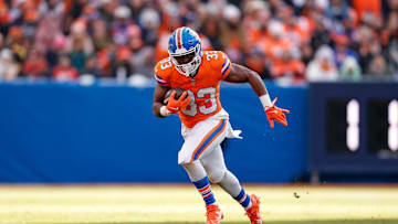 Jan 5, 2025; Denver, Colorado, USA; Denver Broncos running back Javonte Williams (33) runs the ball in the second quarter against the Kansas City Chiefs at Empower Field at Mile High. Mandatory Credit: Isaiah J. Downing-Imagn Images