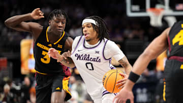 Mar 11, 2025; Kansas City, MO, USA; Kansas State Wildcats guard Dug McDaniel (0) drives to the basket around Arizona State Sun Devils guard Joson Sanon (3) during the first half at T-Mobile Center. Mandatory Credit: William Purnell-Imagn Images