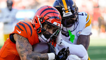 Cincinnati Bengals running back Chase Brown (30) is knocked out of bounds short of the goal line by Pittsburgh Steelers cornerback Joey Porter Jr. (24) in the first quarter of the NFL Week 13 game between the Cincinnati Bengals and the Pittsburgh Steelers at Paycor Stadium in downtown Cincinnati on Sunday, Dec. 1, 2024.