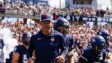 Aug 30, 2025; East Hartford, Connecticut, USA; Connecticut Huskies head coach Jim Mora runs onto the field before the start of the game against the Central Connecticut State Blue Devils at Pratt & Whitney Stadium at Rentschler Field. Mandatory Credit: David Butler II-Imagn Images