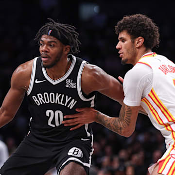 Mar 16, 2025; Brooklyn, New York, USA; Brooklyn Nets center Day'Ron Sharpe (20) is defended by Atlanta Hawks forward Dominick Barlow (0) during the second half at Barclays Center. Mandatory Credit: Vincent Carchietta-Imagn Images