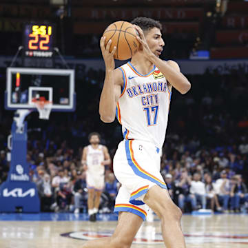 Oct 17, 2024; Oklahoma City, Oklahoma, USA; Oklahoma City Thunder forward Malevy Leons (17) drives to the basket against Atlanta Hawks guard Keaton Wallace (2) during the second half at Paycom Center. Mandatory Credit: Alonzo Adams-Imagn Images