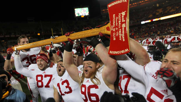 The Badgers hoist the Paul Bunyan Axe after their victory during Wisconsin's 20-7 win over Minnesota.