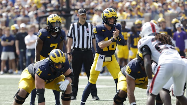 Sep 14, 2024; Ann Arbor, Michigan, USA;  Michigan Wolverines quarterback Davis Warren (16) prepares to run a play against the Arkansas State Red Wolves during the first half at Michigan Stadium. Mandatory Credit: Rick Osentoski-Imagn Images