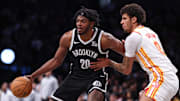 Mar 16, 2025; Brooklyn, New York, USA; Brooklyn Nets center Day'Ron Sharpe (20) is defended by Atlanta Hawks forward Dominick Barlow (0) during the second half at Barclays Center. Mandatory Credit: Vincent Carchietta-Imagn Images