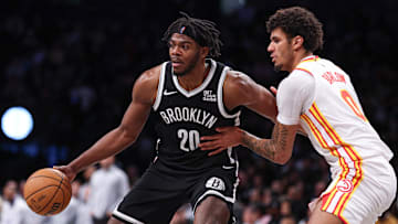 Mar 16, 2025; Brooklyn, New York, USA; Brooklyn Nets center Day'Ron Sharpe (20) is defended by Atlanta Hawks forward Dominick Barlow (0) during the second half at Barclays Center. Mandatory Credit: Vincent Carchietta-Imagn Images