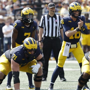 Sep 14, 2024; Ann Arbor, Michigan, USA;  Michigan Wolverines quarterback Davis Warren (16) prepares to run a play against the Arkansas State Red Wolves during the first half at Michigan Stadium. Mandatory Credit: Rick Osentoski-Imagn Images