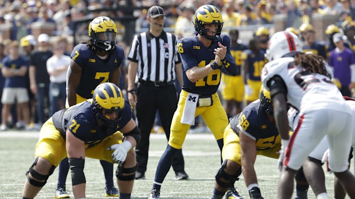 Sep 14, 2024; Ann Arbor, Michigan, USA;  Michigan Wolverines quarterback Davis Warren (16) prepares to run a play against the Arkansas State Red Wolves during the first half at Michigan Stadium. Mandatory Credit: Rick Osentoski-Imagn Images