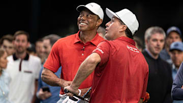 Golfers Tiger Woods and Kevin Kisner warm up at SoFi Center before the golf match between Jupiter Links and Los Angeles Golf Club in the TGL, interactive golf league founded by Woods and Rory McIlroy on January 14, 2025 in Palm Beach Gardens, Florida.