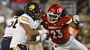 Nov 8, 2025; Louisville, Kentucky, USA;  Louisville Cardinals defensive lineman Wesley Bailey (23) sacks California Golden Bears quarterback Jaron-Keawe Sagapolutele (3) during the second half at L&N Federal Credit Union Stadium. California defeated Louisville 29-26. Mandatory Credit: Jamie Rhodes-Imagn Images