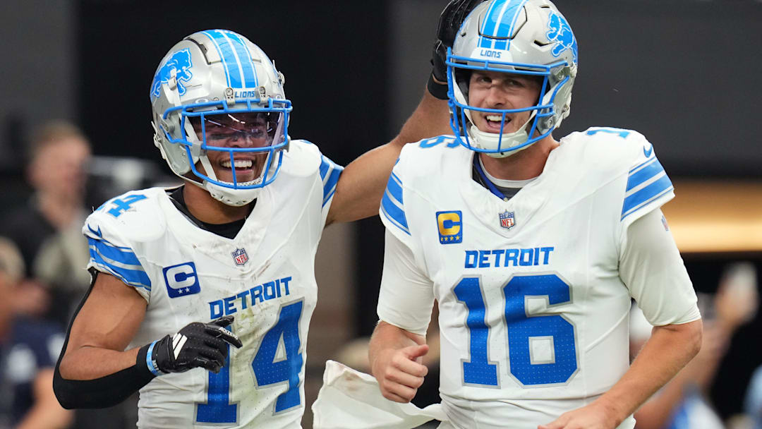 Detroit Lions receiver Amon-Ra St. Brown (14) and quarterback Jared Goff (16) celebrate after completing a hook and ladder play for a touchdown to teammate Jahmyr Gibbs (not pictured) during their game against the Arizona Cardinals at State Farm Stadium in Glendale, Ariz., Sep 22, 2024.