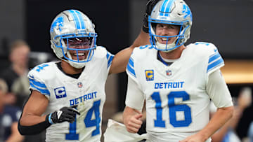 Detroit Lions receiver Amon-Ra St. Brown (14) and quarterback Jared Goff (16) celebrate after completing a hook and ladder play for a touchdown to teammate Jahmyr Gibbs (not pictured) during their game against the Arizona Cardinals at State Farm Stadium in Glendale, Ariz., Sep 22, 2024.