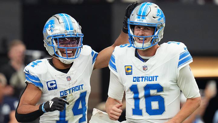 Detroit Lions receiver Amon-Ra St. Brown (14) and quarterback Jared Goff (16) celebrate after completing a hook and ladder play for a touchdown to teammate Jahmyr Gibbs (not pictured) during their game against the Arizona Cardinals at State Farm Stadium in Glendale, Ariz., Sep 22, 2024.