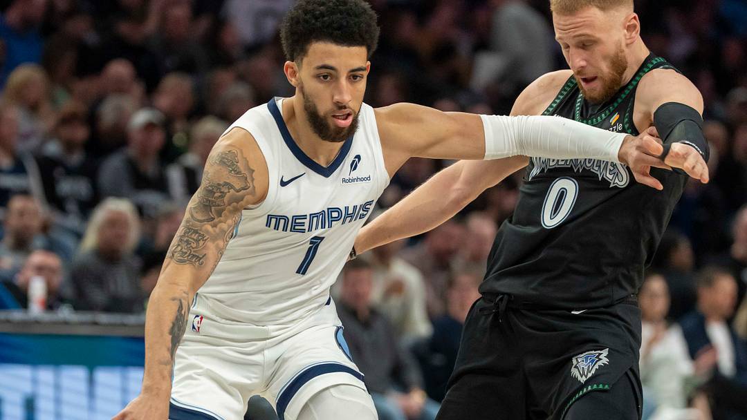 Mar 3, 2026; Minneapolis, Minnesota, USA; Memphis Grizzlies guard Scotty Pippen Jr. (1) dribbles the ball and pushes away from Minnesota Timberwolves guard Donte DiVincenzo (0) in the first half at Target Center. Mandatory Credit: Jesse Johnson-Imagn Images