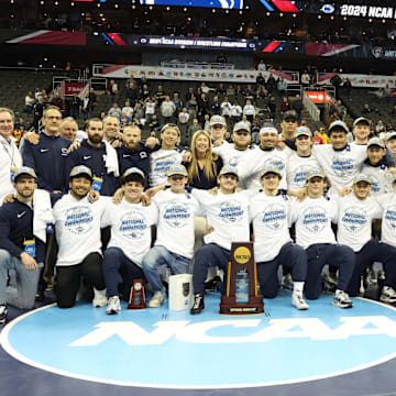 The Penn State Nittany Lions pose with the trophy after winning the team title at the 2024 NCAA Wrestling Championships. 