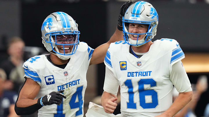 Detroit Lions receiver Amon-Ra St. Brown (14) and quarterback Jared Goff (16) celebrate after completing a hook and ladder play for a touchdown to teammate Jahmyr Gibbs (not pictured) during their game against the Arizona Cardinals at State Farm Stadium in Glendale, Ariz., Sep 22, 2024.