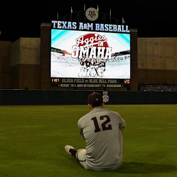 Jun 9, 2024; College Station, TX, USA; Texas A&M infielder Ryan Targac (12) sits in the outfield after the sweep over Oregon sending them to Ohama at Olsen Field, Blue Bell Park Mandatory Credit: Maria Lysaker-Imagn Images