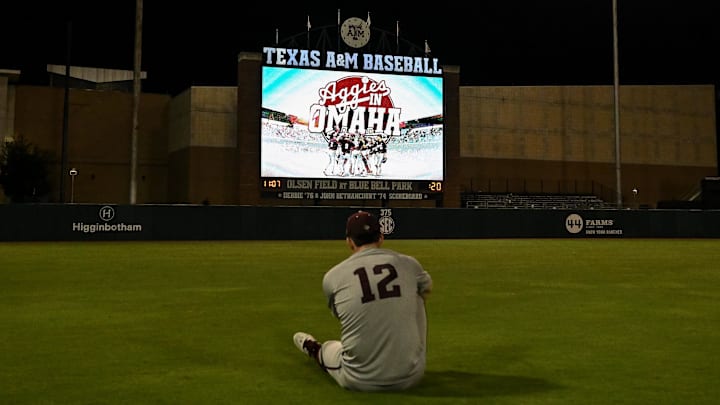 Jun 9, 2024; College Station, TX, USA; Texas A&M infielder Ryan Targac (12) sits in the outfield after the sweep over Oregon sending them to Ohama at Olsen Field, Blue Bell Park Mandatory Credit: Maria Lysaker-Imagn Images