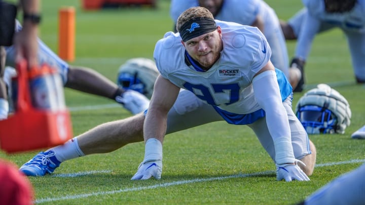 Defensive lineman Aidan Hutchinson stretches during the Detroit Lions training camp at their training facility in Allen Park, Mich. on Monday, July 29, 2024.