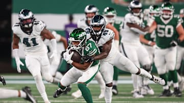 Aug 22, 2025; East Rutherford, New Jersey, USA; New York Jets wide receiver Brandon Smith (87) is tackled by Philadelphia Eagles cornerback Jakorian Bennett (49) during the first half at MetLife Stadium. Mandatory Credit: Vincent Carchietta-Imagn Images