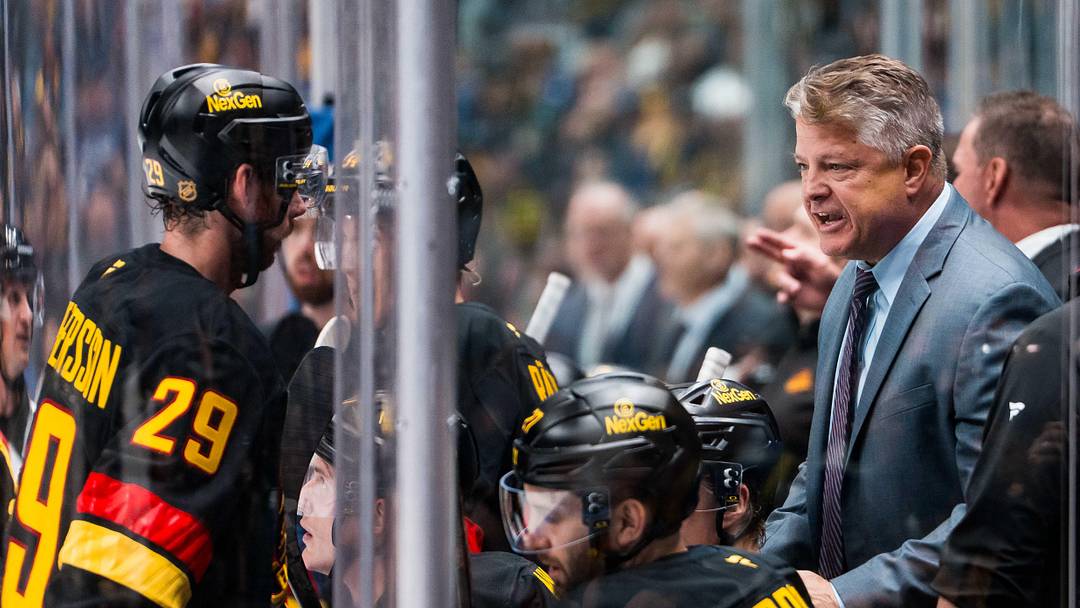 Oct 9, 2025; Vancouver, British Columbia, CAN; Vancouver Canucks assistant coach Kevin Dean speaks to defenseman Marcus Pettersson (29) against the Calgary Flames in the first period at Rogers Arena. Mandatory Credit: Bob Frid-Imagn Images