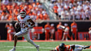 Sep 7, 2024; Stillwater, Oklahoma, USA; Arkansas Razorbacks quarterback Taylen Green (10) breaks a tackle by Oklahoma State Cowboys 