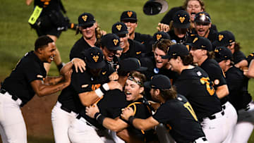 Tennessee's Cal Stark (10) and Tennessee's Marcus Phillips (44) and the center of the dogpile as the teams celebrates their win over Evansville in the Knoxville Super Regional of the NCAA baseball tournament on Sunday, June 9, 2024 in Knoxville, Tenn.