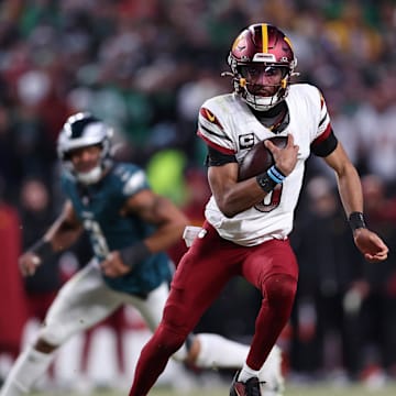 Jan 26, 2025; Philadelphia, PA, USA; Washington Commanders quarterback Jayden Daniels (5) runs with the ball against the Philadelphia Eagles during the second half in the NFC Championship game at Lincoln Financial Field. Mandatory Credit: Bill Streicher-Imagn Images