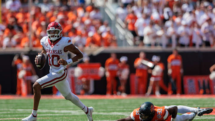 Sep 7, 2024; Stillwater, Oklahoma, USA; Arkansas Razorbacks quarterback Taylen Green (10) breaks a tackle by Oklahoma State Cowboys 