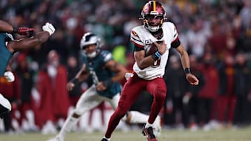 Jan 26, 2025; Philadelphia, PA, USA; Washington Commanders quarterback Jayden Daniels (5) runs with the ball against the Philadelphia Eagles during the second half in the NFC Championship game at Lincoln Financial Field. 