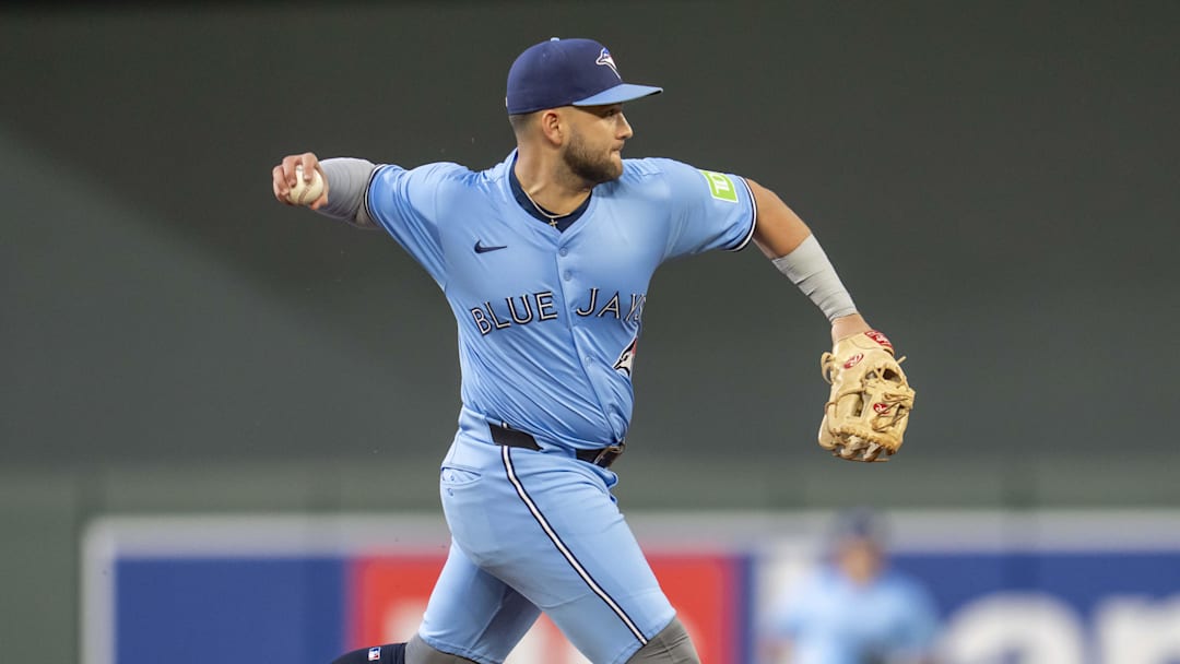Jun 6, 2025; Minneapolis, Minnesota, USA; Toronto Blue Jays shortstop Bo Bichette (11) throws the ball to first base for an out against the Minnesota Twins in the fifth inning at Target Field. 