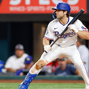 Aug 12, 2025; Arlington, Texas, USA; Texas Rangers shortstop Josh Smith (8) squares around to bunt during the fifth inning against the Arizona Diamondbacks at Globe Life Field. 