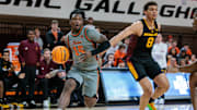 Feb 9, 2025; Stillwater, Oklahoma, USA; Oklahoma State Cowboys guard Jamyron Keller (14) drives to the basket around Arizona State Sun Devils forward Basheer Jihad (8) during the first half at Gallagher-Iba Arena. Mandatory Credit: William Purnell-Imagn Images