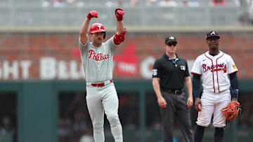 Jun 29, 2025; Cumberland, Georgia, Philadelphia Phillies first baseman Otto Kemp (4) reacts to his double next to Atlanta Braves second baseman Ozzie Albies (1) during the fifth inning at Truist Park. Mandatory Credit: Mady Mertens-Imagn Images