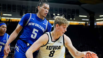 Iowa Hawkeyes forward Cooper Koch (8) drives into the lane against New Orleans Privateers guard James White (5) Sunday, Dec. 15, 2024 at Carver-Hawkeye Arena in Iowa City, Iowa.
